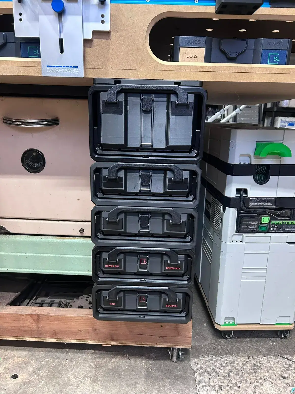 Vertical stack of Graphite Modular storage boxes mounted beneath a workshop bench